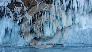 Bizarre stalactite icicles cover the base of the rock.