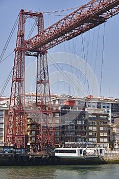 Bizkaia red iron hanging bridge and Nervion river. Basque country photo