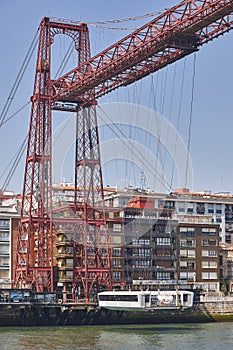 Bizkaia red iron hanging bridge and Nervion river. Basque country photo