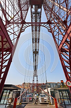 Bizkaia red iron hanging bridge and Nervion river. Euskadi