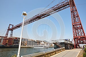 Bizkaia red iron hanging bridge and Nervion river. Euskadi photo