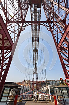 Bizkaia red iron hanging bridge and Nervion river. Euskadi photo