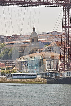 Bizkaia red iron hanging bridge and Nervion river. Euskadi photo