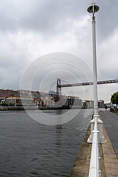 Bizkaia suspension bridge with metal structure considered world heritage for transport with cloudy sky crossing the river