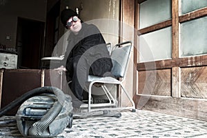 Bizzare man sitting on a chair