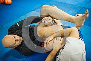 BJJ Brazilian jiu-jitsu ground fight. Leg lock calf slicer submission photo