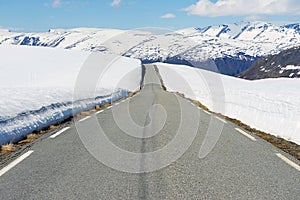 Bjorgavegen mountain road between Aurland and Laerdal with sides still covered with snow in june in Sogn og Fjordane, Norway.