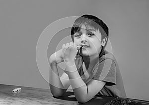 Blac and white Portrait happy boy sitting alone and looking at camera with smiling face Kid playing playing board game strategy