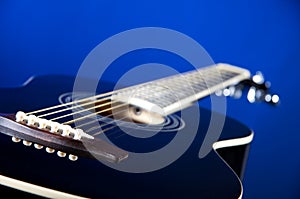 Black Acoustic Guitar On Blue