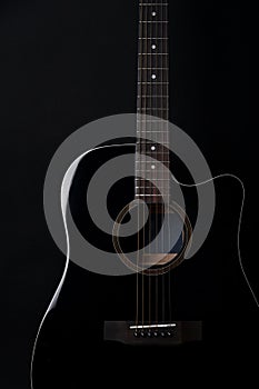 Black acoustic guitar studio shot on black background with copyspace, Guitar is favorite music.