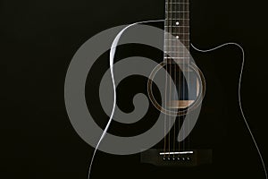 Black acoustic guitar studio shot on black background with copyspace, Guitar is favorite music instrument