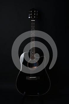 Black acoustic guitar studio shot on black background with copyspace, Guitar is favorite music instrument