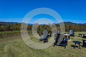 Black Adirondack Chairs on Green Grass Outdoors in the Mountains