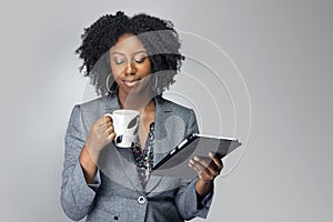 Black Female Businesswoman Keynote Speaker Posing with a Tablet and Coffee photo