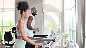 Black African American couple running on the treadmill at fitness club. Healthy lifestyle, training in gym