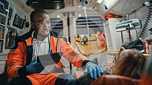 Black African American EMS Professional Paramedic Using Tablet Computer to Fill a Questionnaire fo