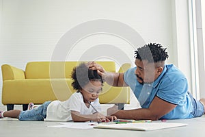 Black African American family dad son drawing together at home.