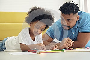 Black African American family dad son drawing together at home.