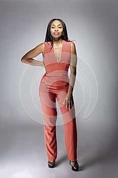 Black African American Fashion Model Wearing an Orange Jumpsuit