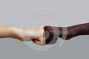 The black African-American hand and the white European hand give a blow to the partnership and cooperation agreement against a