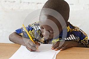 Black African Boy at School taking notes during class