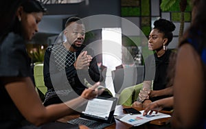 Black african business analyst in strategy meeting. Using hand gestures with serious and concerned tone photo