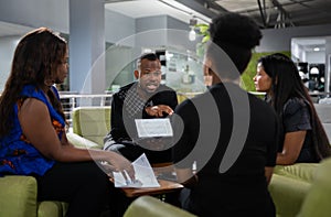 Black african businessman presenting statistics using a digital tablet for a start up business