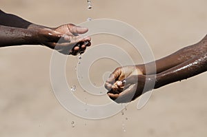 Black African children Washing Hands with Water with Copy Space photo