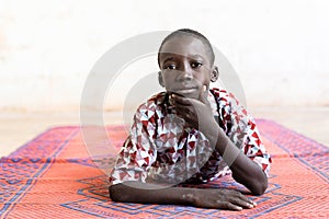 Black African Ethnicity Boy Posing as a Model lying down on Mat