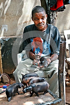 Black African man wood carver working art workshop