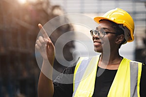 Black African smart women engineer worker finger point counting stock in factory industry warehouse proud smiling
