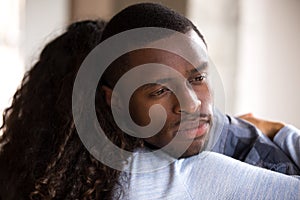 Black African woman embracing sad frustrated man
