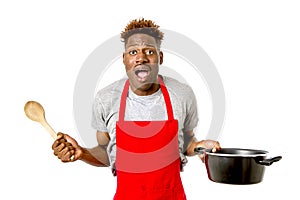 Black afro american man home cook in chef apron cooking pot and