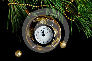 Black Alarm clock and fir tree branch, gold christmas decorations green velours glitte