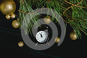 Black Alarm clock and fir tree branch, gold christmas decorations green velours glitte