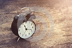 Black Alarm Clock vintage on wooden table background