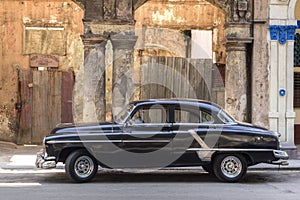 Black american car parked in Prado, Havana