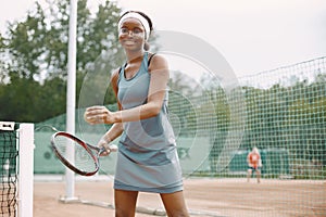 Black american female tennis player playing on the court outdoors