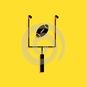 Black American football with goal post icon isolated on yellow background. Long shadow style. Vector