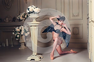 Black Angel. Beautiful model woman dancer in underwear, wings