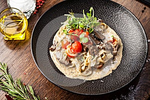 Black Angus beef tagliatelle pasta with fresh black truffles and parmegano. Delicious healthy traditional food closeup