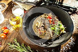 Black Angus beef tagliatelle pasta with fresh black truffles and parmegano. Delicious healthy traditional food closeup