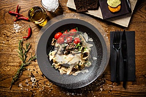 Black Angus Pasta served in a black bowl in restaurant