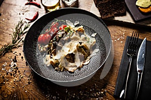 Black Angus Pasta served in a black bowl in restaurant