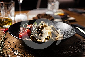 Black Angus Pasta served in a black bowl in restaurant