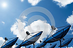 Black antenna communication satellite dish on blue sky