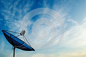 black antenna communication satellite dish on blue sky background