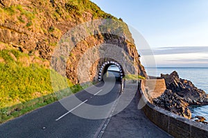 Coastal road with tunnel, Northern Ireland, UK