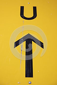 Black arrow leading to a U, yellow background. German sign for detour photo