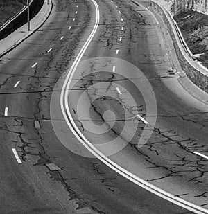 Black asphalt road and white dividing lines. Highway traffic road. Road patches